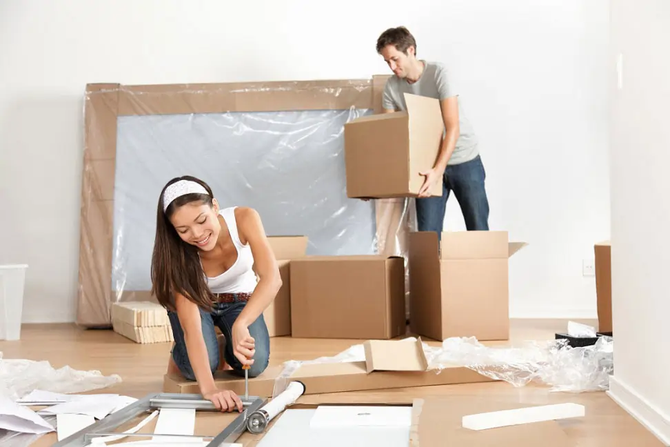 Sewika crew packing household items into labelled cartons